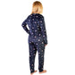 Person wearing navy blue pajamas with star pattern on a white background